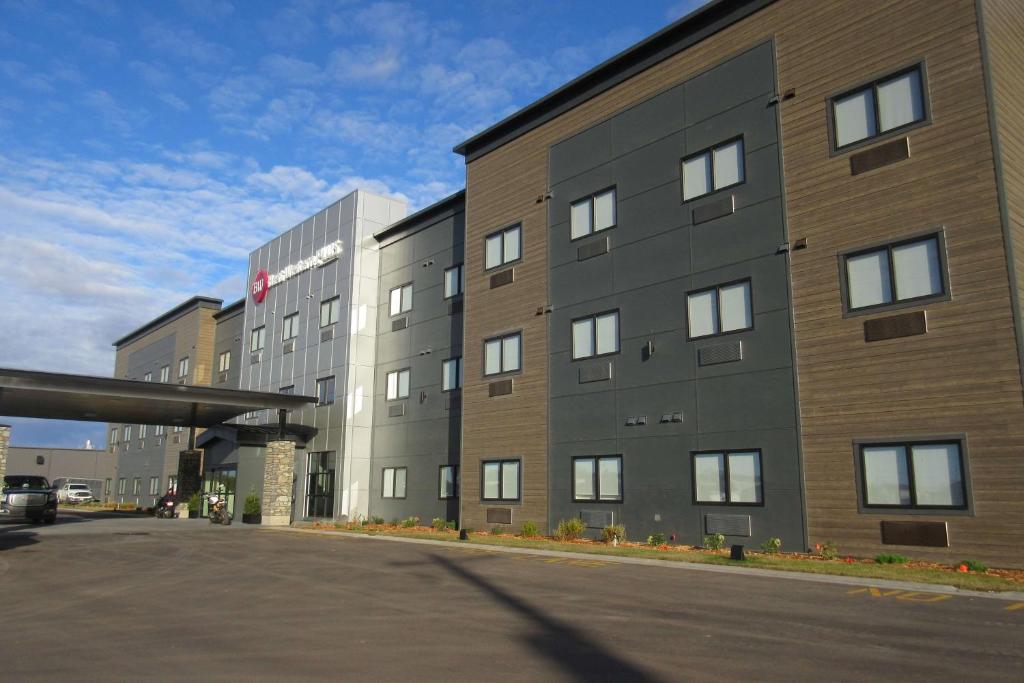 a large building with a parking lot in front of it at Best Western Plus Winkler in Winkler