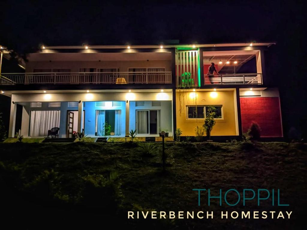 a house lit up at night with lights at Riverbench Homestay Munnar, Anaviratty in Anaviratty
