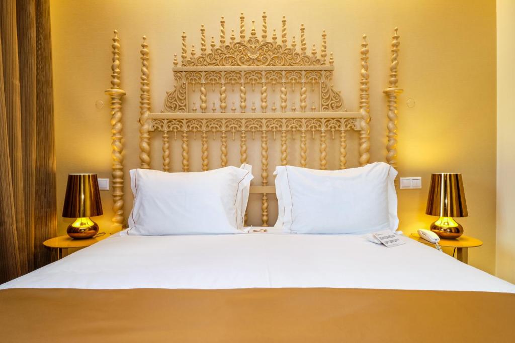 a bedroom with a large white bed with two lamps at Sintra Boutique Hotel in Sintra