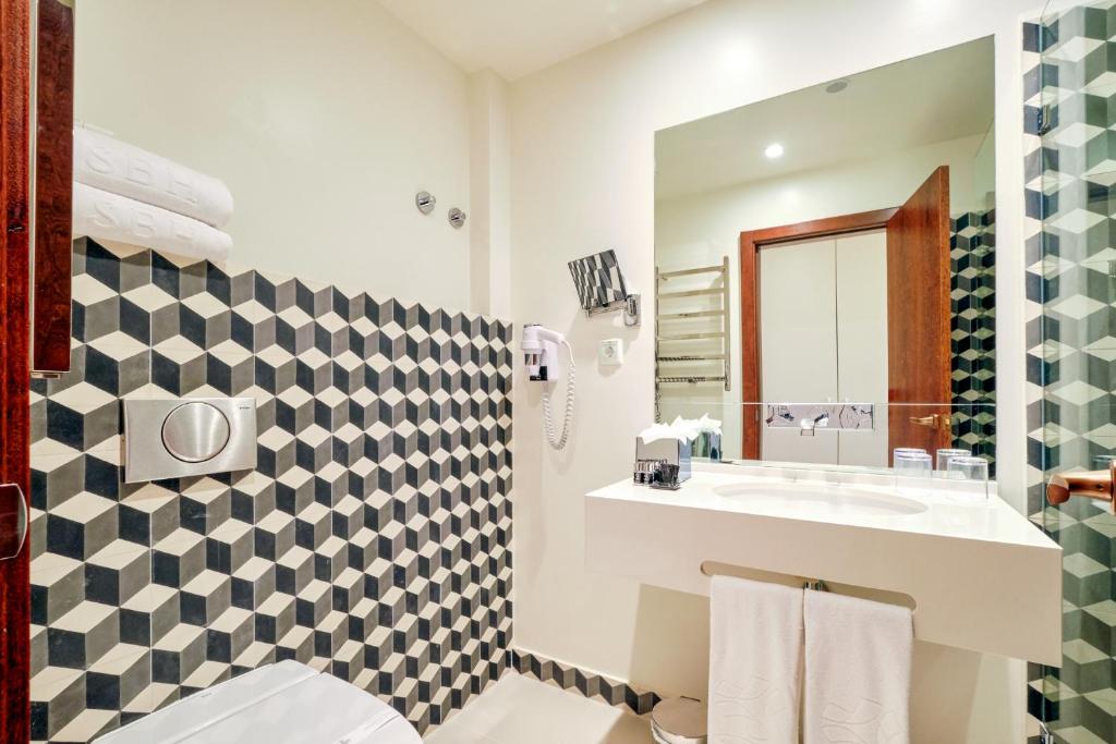 a bathroom with a sink and a mirror at Sintra Boutique Hotel in Sintra
