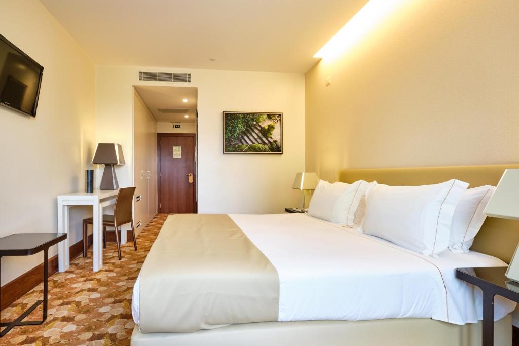 a large white bed in a hotel room at Sintra Boutique Hotel in Sintra