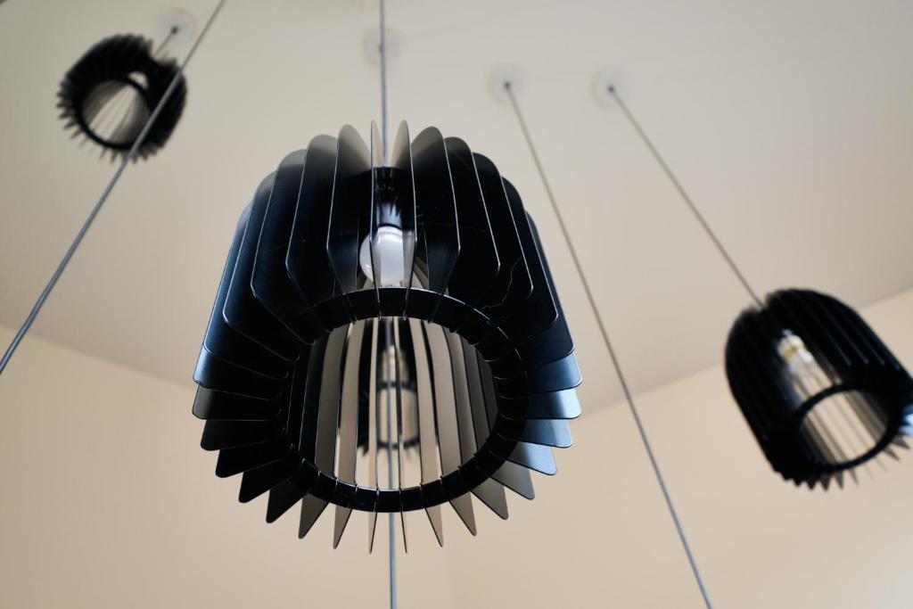 a ceiling fan with three lights hanging from it at Sintra Boutique Hotel in Sintra