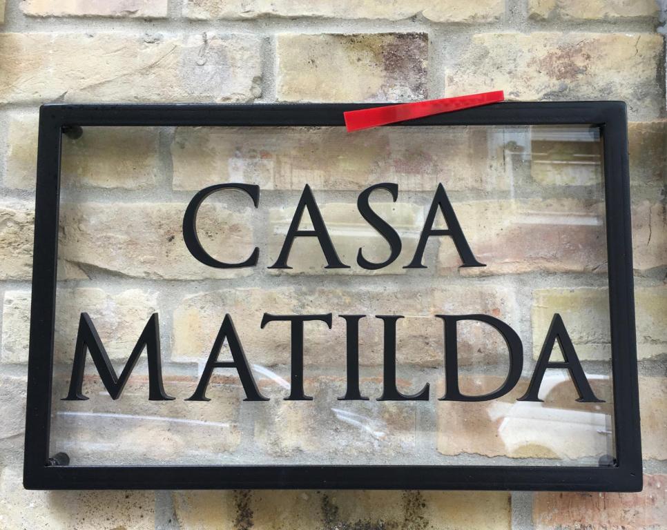 a sign on a brick wall with the words casa matilda at Casa Matilda in Porto SantʼElpidio