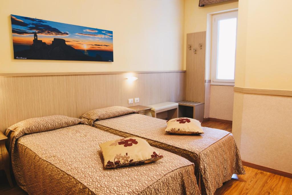 Postel nebo postele na pokoji v ubytování Hotel Corallo