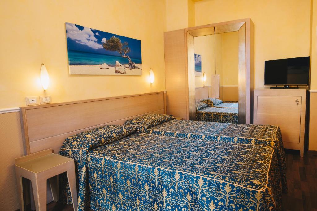 Postel nebo postele na pokoji v ubytování Hotel Corallo