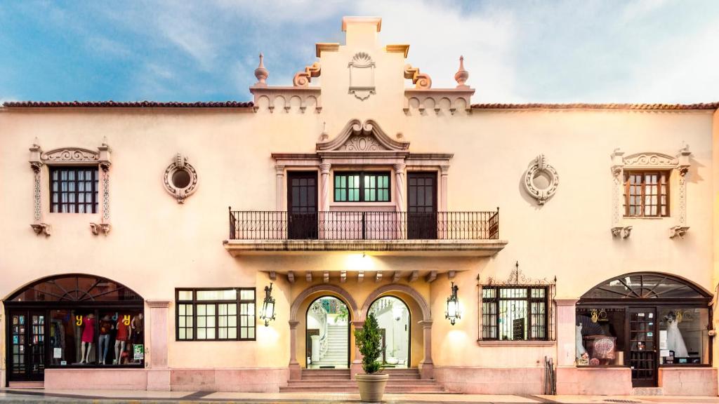 a building with a clock tower on top of it at Hotel Urdiñola Saltillo in Saltillo