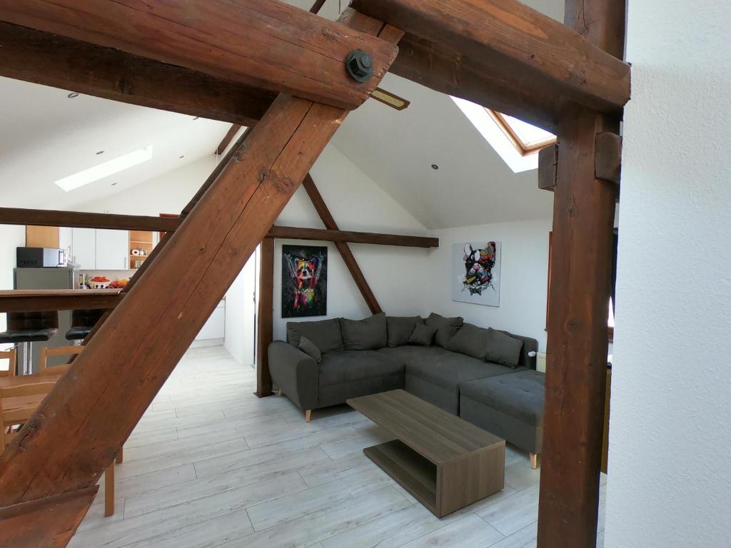 a living room with a couch and a table at Die Göttinger Ferienwohnung, alt trifft modern! in Göttingen