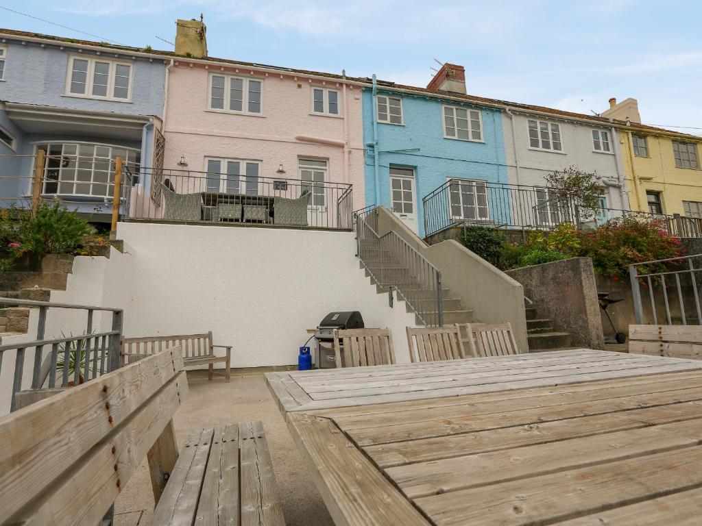 a group of houses with a wooden deck in front of them at Dory Cottage in Salcombe