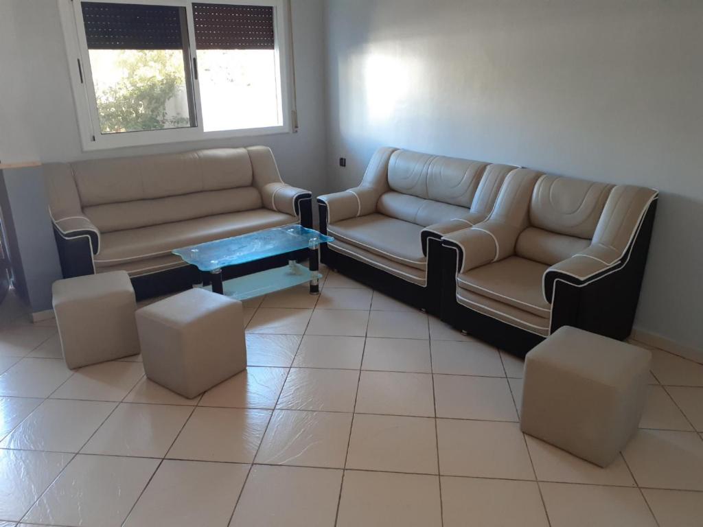a living room with two couches and a coffee table at Newimo saidia in Saïdia