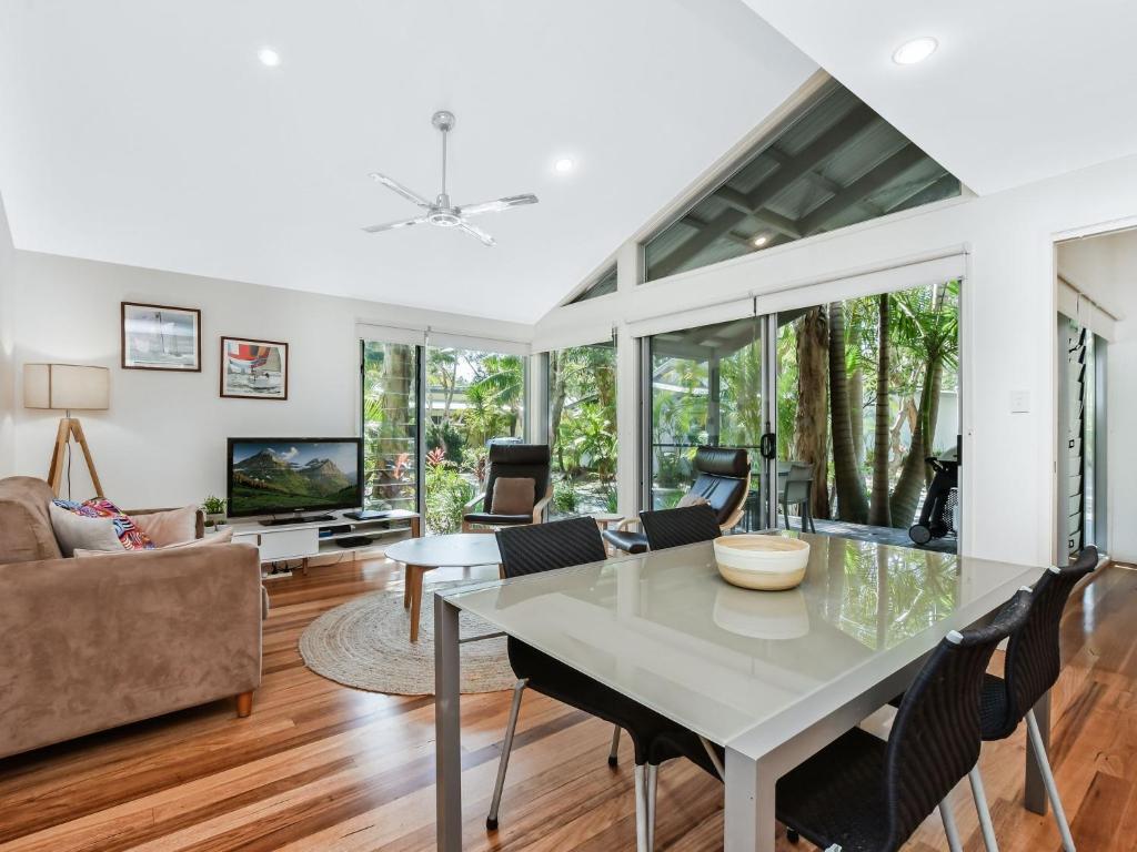 a living room with a table and chairs at Mobys Beach house 11 in Boomerang Beach