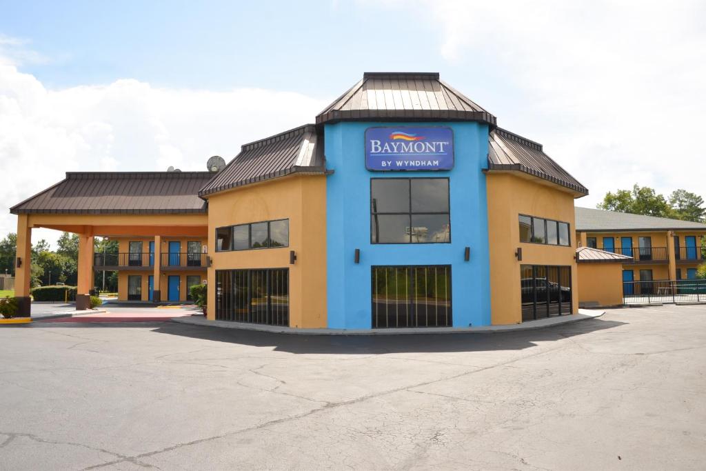 a building with a sign on the front of it at Baymont by Wyndham Santee in Santee