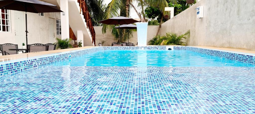 a swimming pool with blue tiles on the side of a building at Casa Chujuk by Spirit Group in Holbox Island