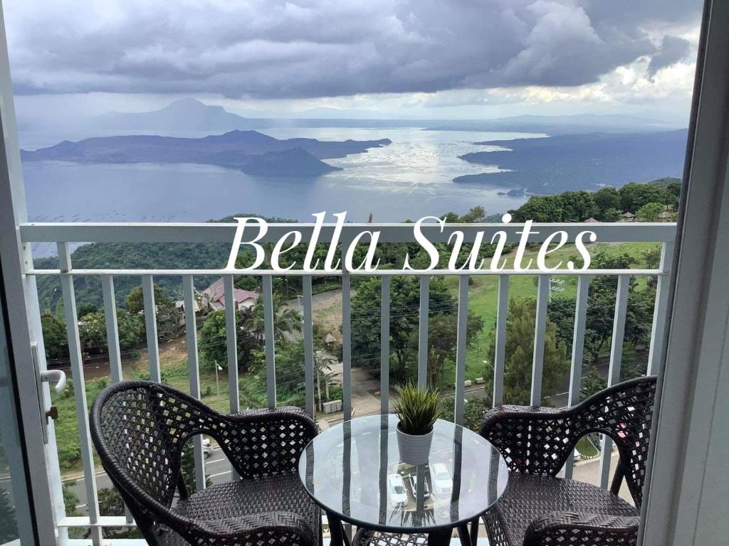 a table and chairs on a balcony with a view of the ocean at Bella Suites at Wind Residences Tagaytay in Tagaytay