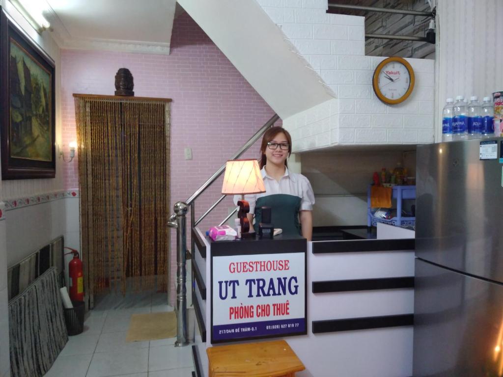 een vrouw staat achter een bord in een keuken bij Guest House UTTRANG in Ho Chi Minh-stad