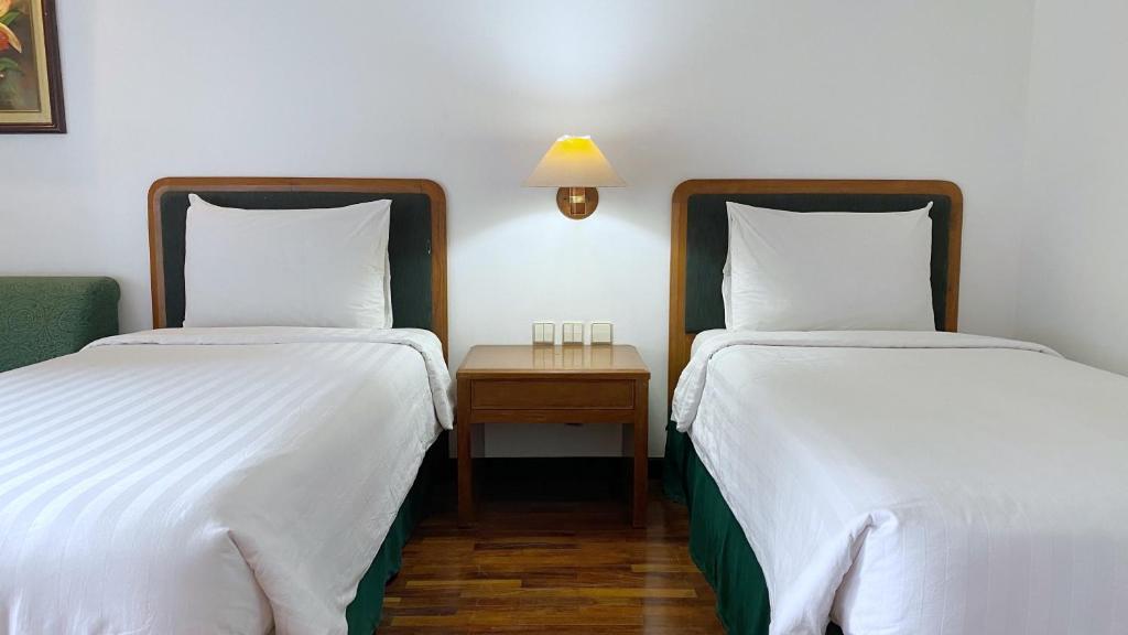 Postel nebo postele na pokoji v ubytování Grand Whiz Hotel Bromo