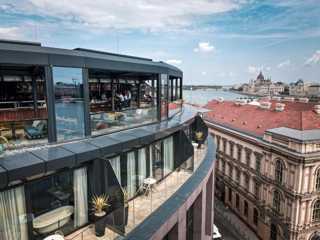 a boat sitting on top of a dock next to a building at Hotel Clark Budapest - Adults Only in Budapest