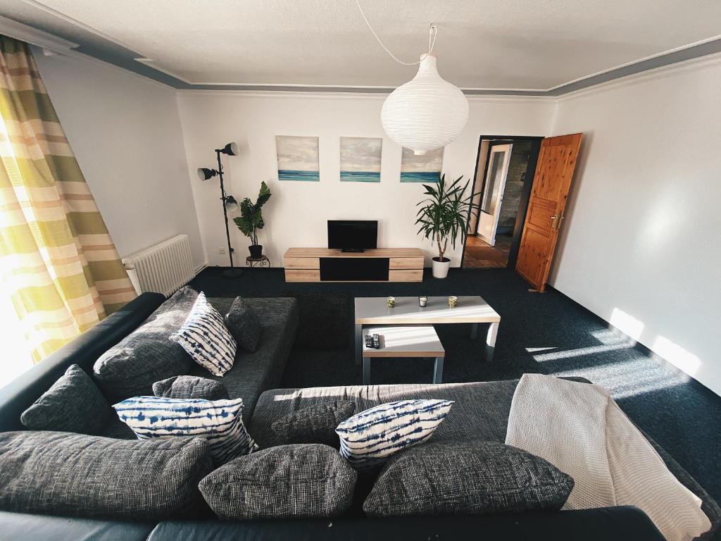 a living room with a couch and a table at EcoLodge Bungalow in Oesterdeichstrich