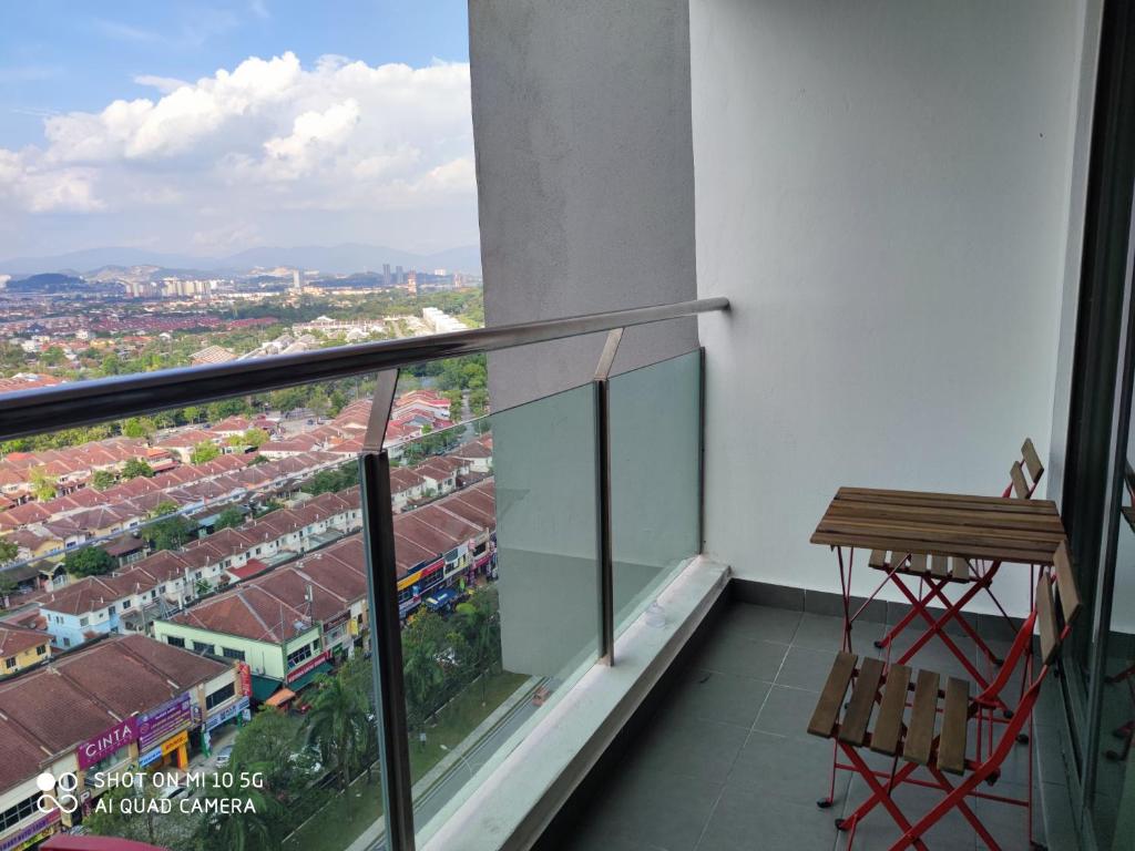a balcony with a table and a view of a train at EVO Soho Suites, Bangi in Kampong Sungai Ramal Dalam
