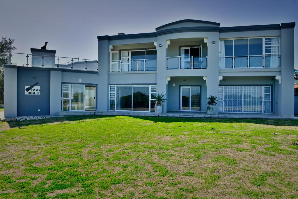 a large house with a yard in front of it at Cannon House in Cannon Rocks