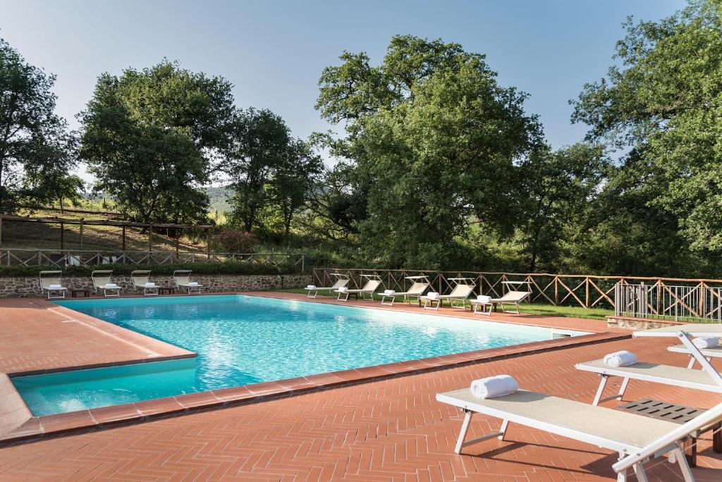 basen z leżakami obok w obiekcie Agriturismo L'Incrociata w mieście Bucine