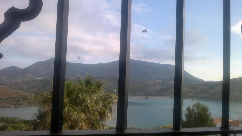 a window with a view of a lake and mountains at Casas Azahar-Alucema in Zahara de la Sierra