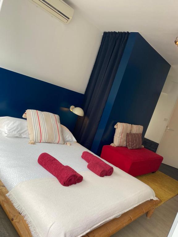 a bedroom with a bed with two red pillows on it at Studio Peralta in Liège