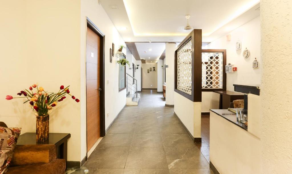 a hallway with a vase of flowers on a table at Hotel Seven- Center of City Chandigarh in Chandīgarh