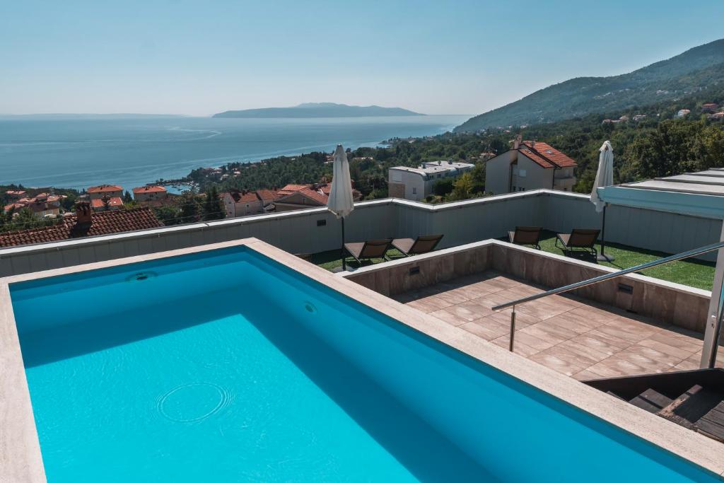 a swimming pool on the roof of a house at Apartment Mara Opatija with rooftop swimming pool in Ičići