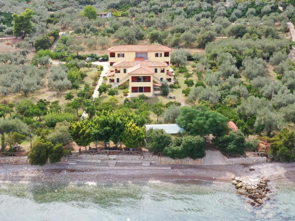 an aerial view of a house next to the water at Magda Hotel Apartments in Ancient Epidauros