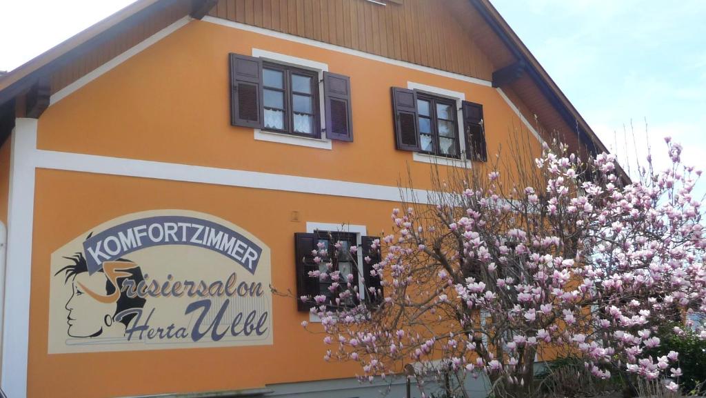 a building with a sign on the side of it at Gästehaus Ulbl in Kitzeck im Sausal