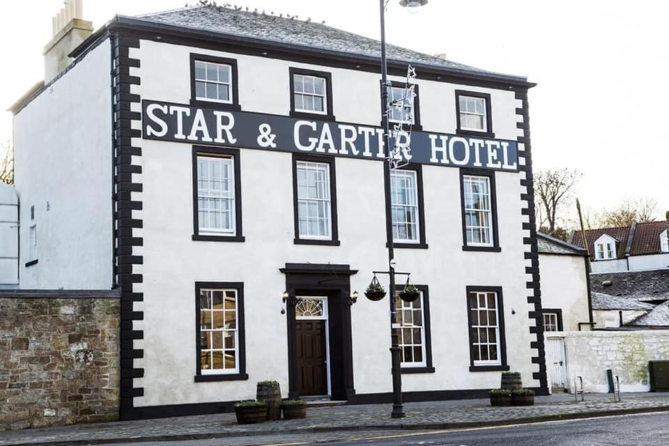 a building with a sign on the front of it at The Star and Garter Hotel in Linlithgow