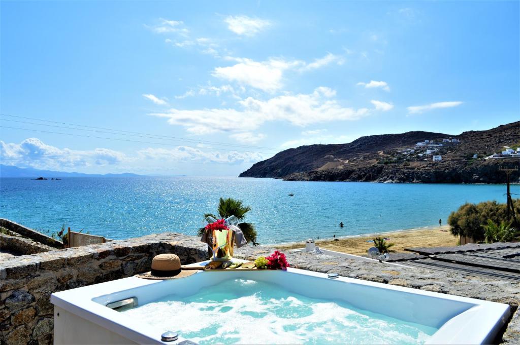a bath tub with a view of the ocean at Sea Side Studios & Houses in Kalo Livadi