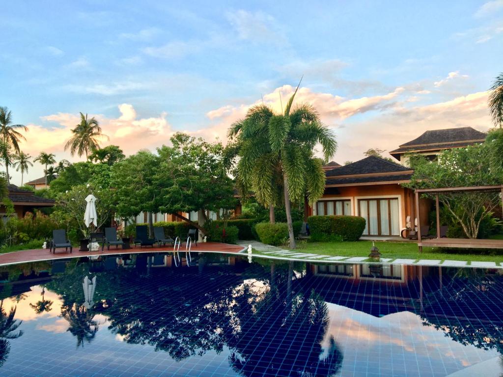 a swimming pool in front of a house at Villa Samba Victoria Resort, Koh Yao Noi in Ko Yao Noi