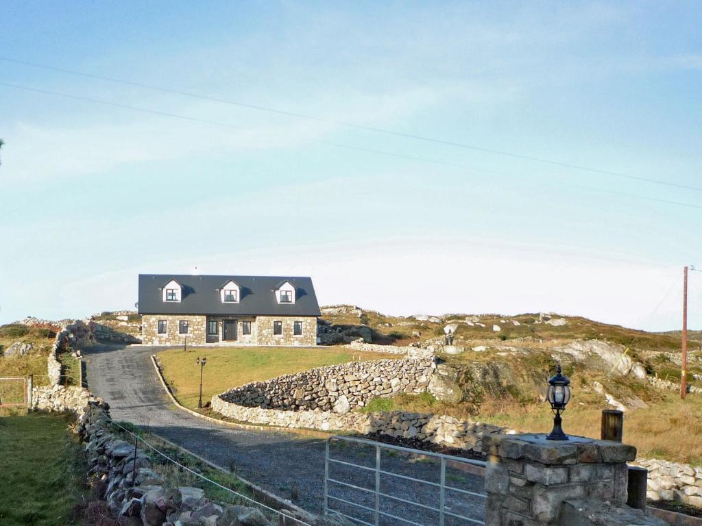a house on top of a hill with a road at Cnocan Na Cuaig Carraroe by Trident Holiday Homes in Carraroe