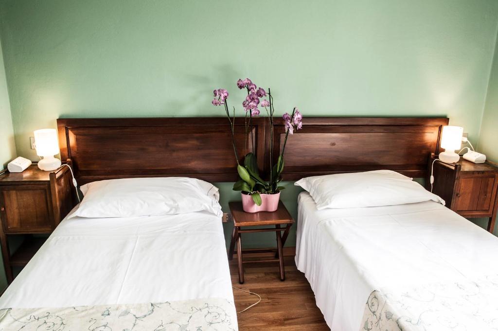 Posteľ alebo postele v izbe v ubytovaní Albergo Bologna