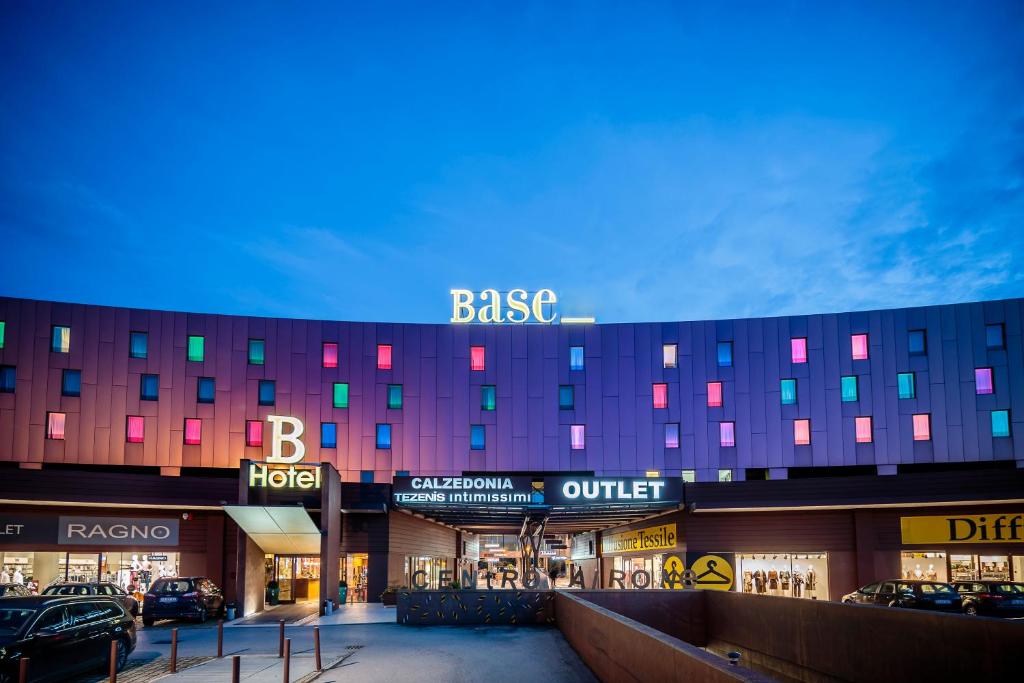 a large building with a baze sign on top of it at Base Hotel in Noventa di Piave