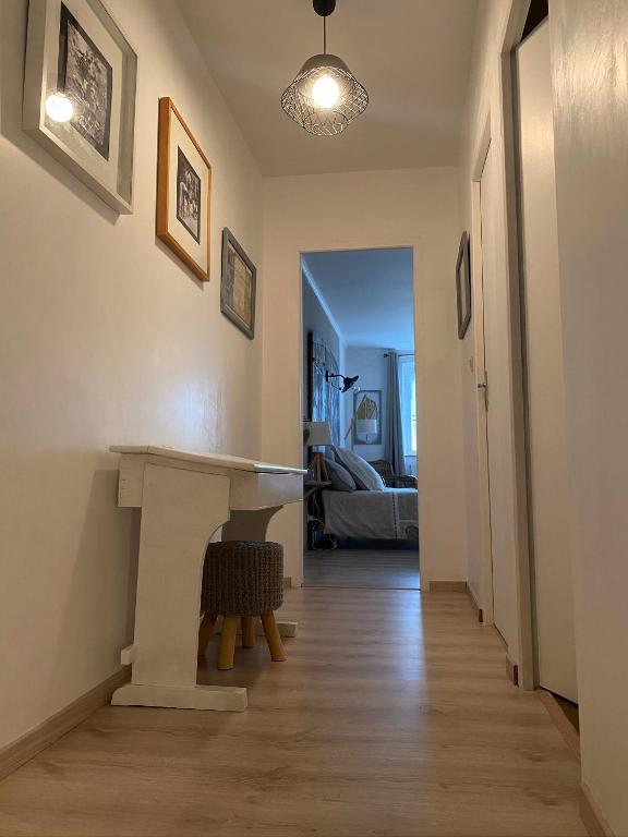 a hallway with a white table and a room at Au P’Tit Cosy in Bazincourt-sur-Saulx