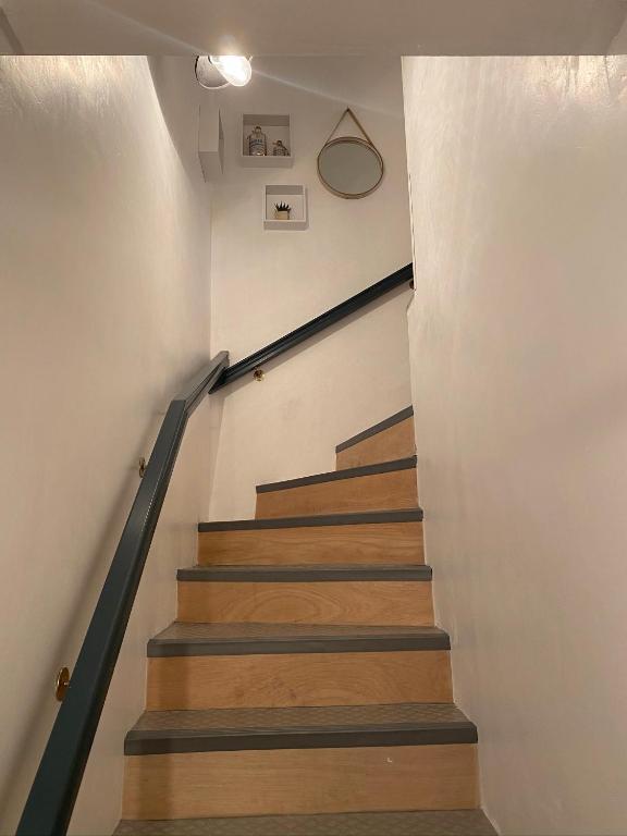 a staircase in a house with wooden floors at Au P’Tit Cosy in Bazincourt-sur-Saulx