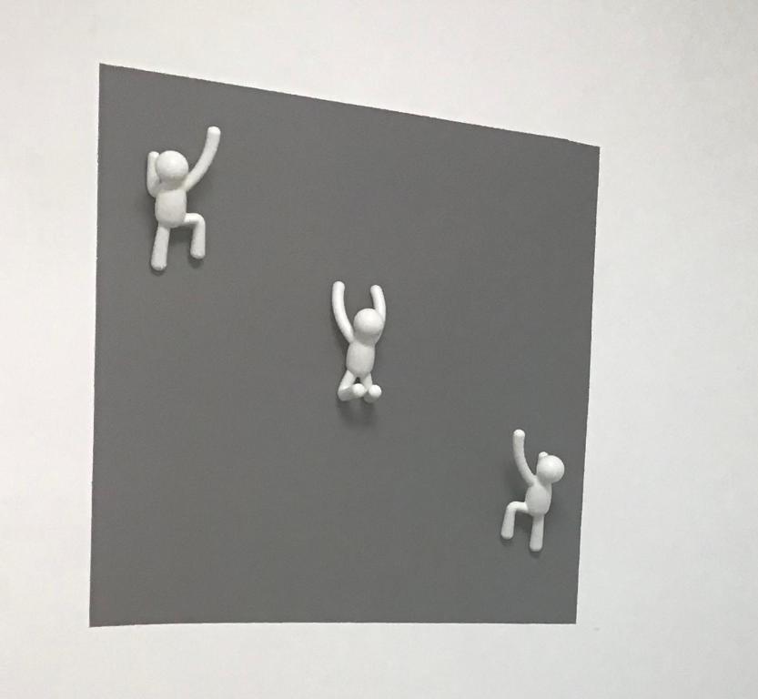 three figurines of a person with their arms in the air at Au P’Tit Cosy in Bazincourt-sur-Saulx