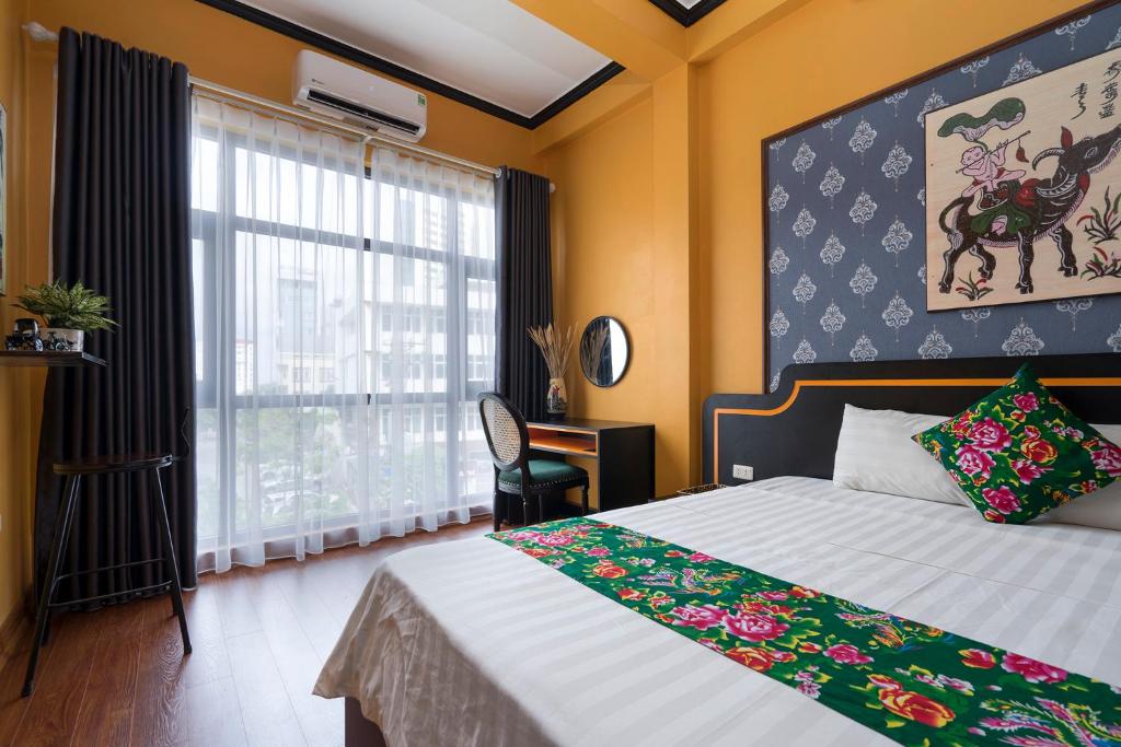 a bedroom with a bed and a large window at VietHouse Homestay Ha Long in Ha Long