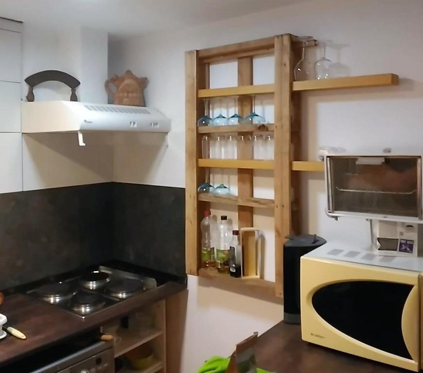 a kitchen with a stove and a microwave at CALANURI in García