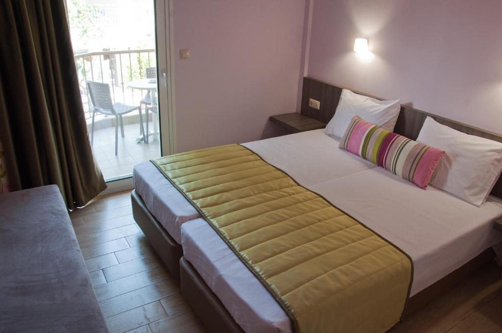 Postel nebo postele na pokoji v ubytování Hotel Olympos