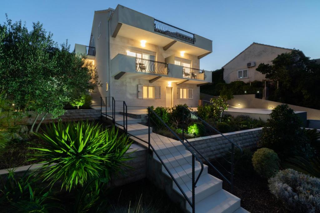 a house with stairs leading up to it at night at WISH Apartments in Korčula