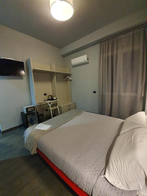 Postel nebo postele na pokoji v ubytování Alma Hotel