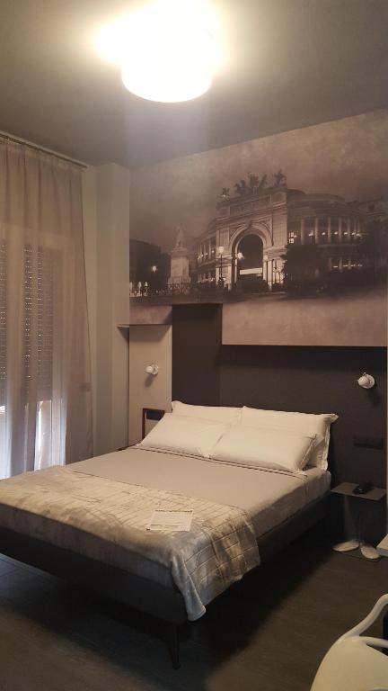 Postel nebo postele na pokoji v ubytování Alma Hotel