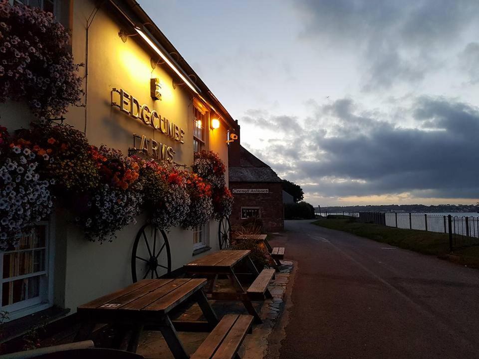 a couple of benches outside of a building at Edgcumbe Arms in Torpoint