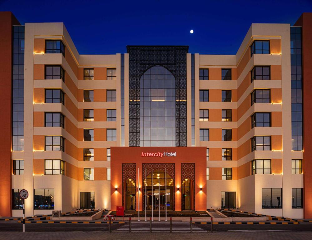 a hotel with the front of the hotel at night at IntercityHotel Nizwa in Nizwa