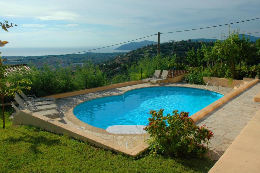 a swimming pool in the yard of a house at SOPHIES HOMES VILLA PANORAMIC SEA VIEW and POOL in Mandelieu-la-Napoule