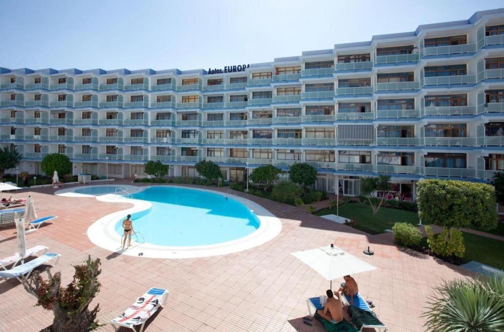 a large apartment building with a large swimming pool at Apartamentos Europa, Playa del Inglés in Playa del Ingles