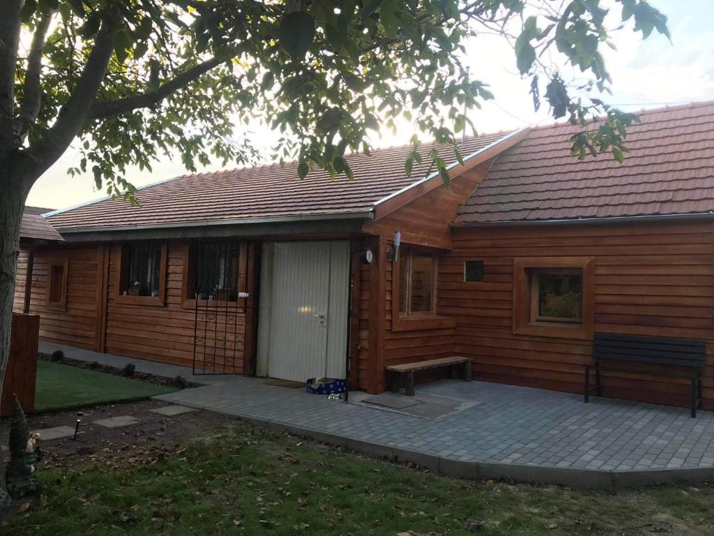 a wooden house with a bench in front of it at MBL Apartments Autumn in Rezi